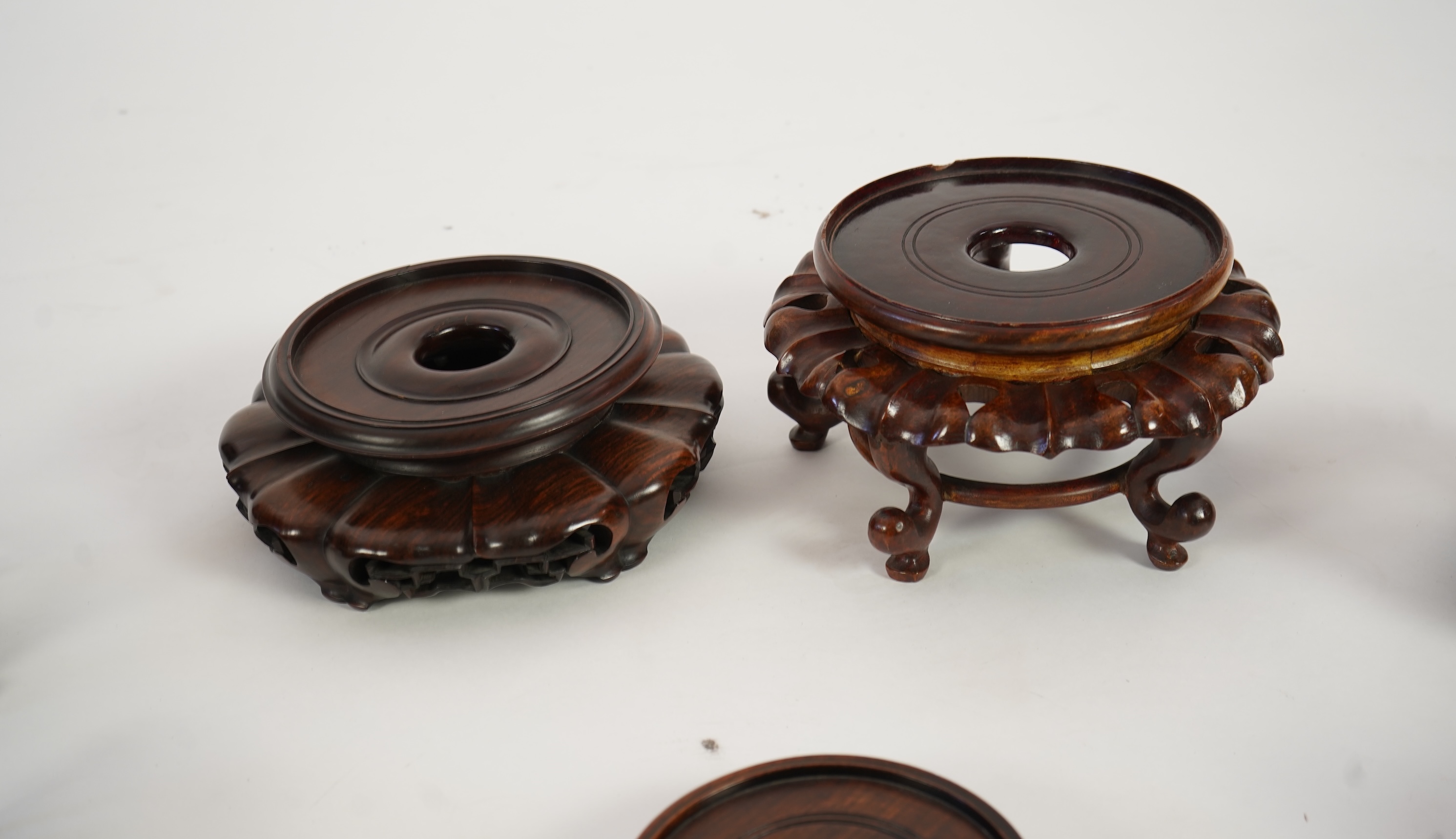 A group of sixteen Chinese hardwood stands together with a Japanese stand, 19th/20th century
